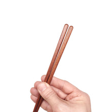 Load image into Gallery viewer, Bubinga Brown Wood Chopsticks hand detail. Custom personalized engraving not shown