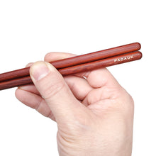 Load image into Gallery viewer, Engraved Padauk red chopsticks end held by hand with custom personalized engraving shown
